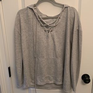 Casual heather gray sweater with criss-cross detail.
